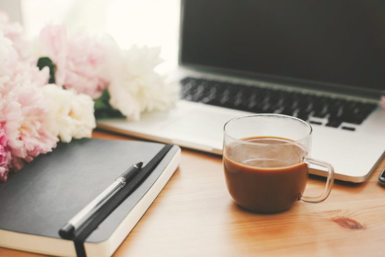 desk with laptop, coffee, notepad